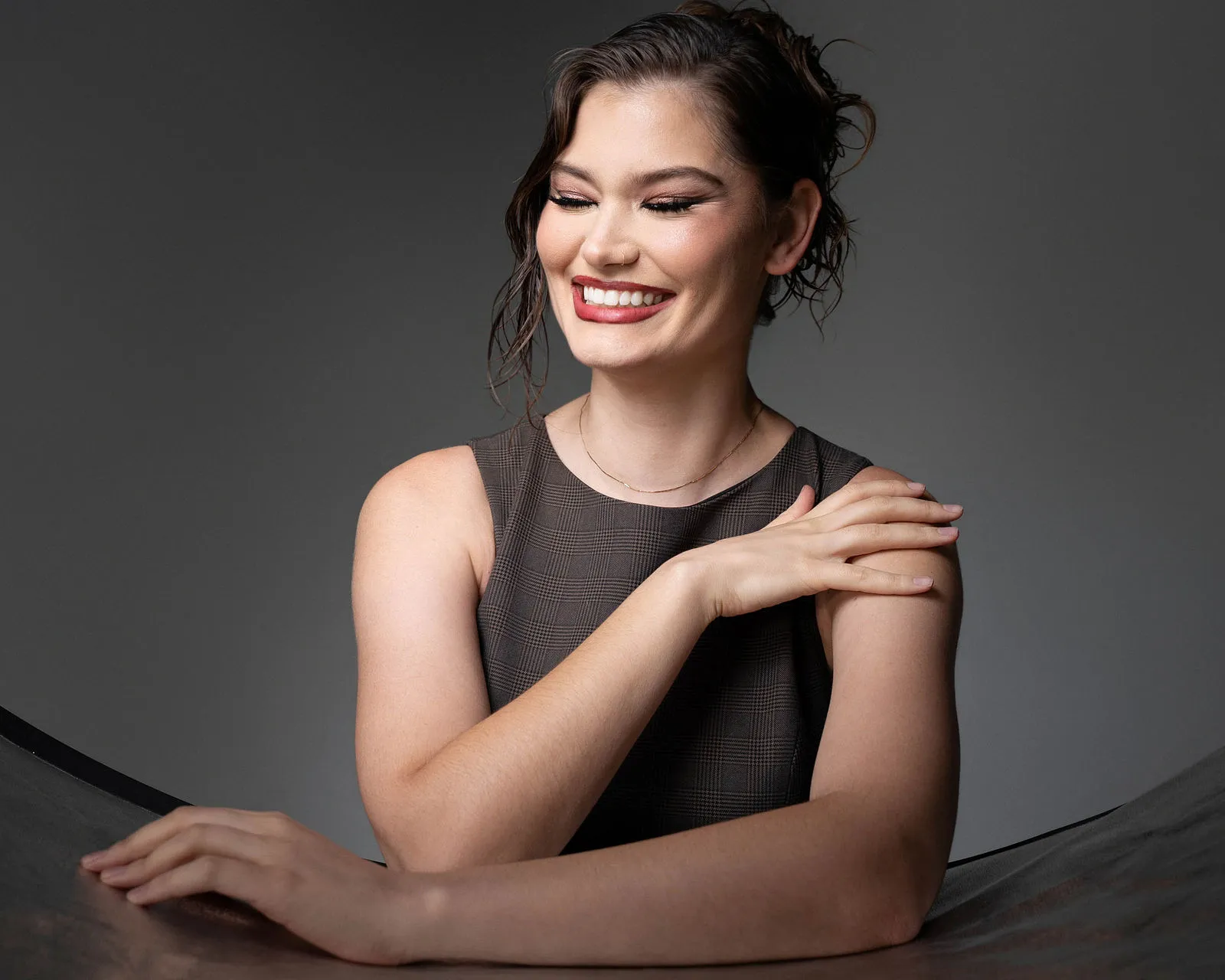 Expressive laughing portrait under constant studio lighting by Pottinger Studios
