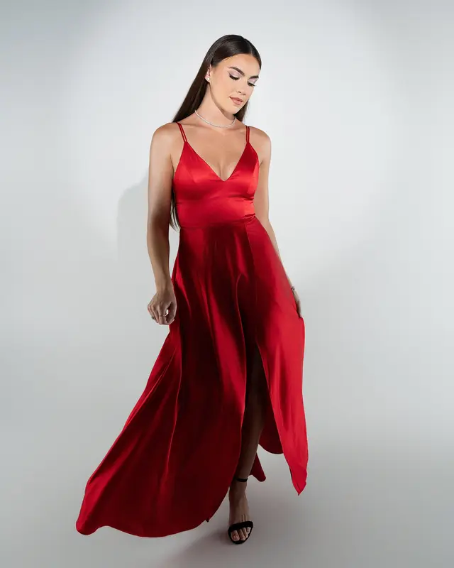 Fashion portrait of a flowing red satin gown lit on white seamless in the studio by Pottinger Studios
