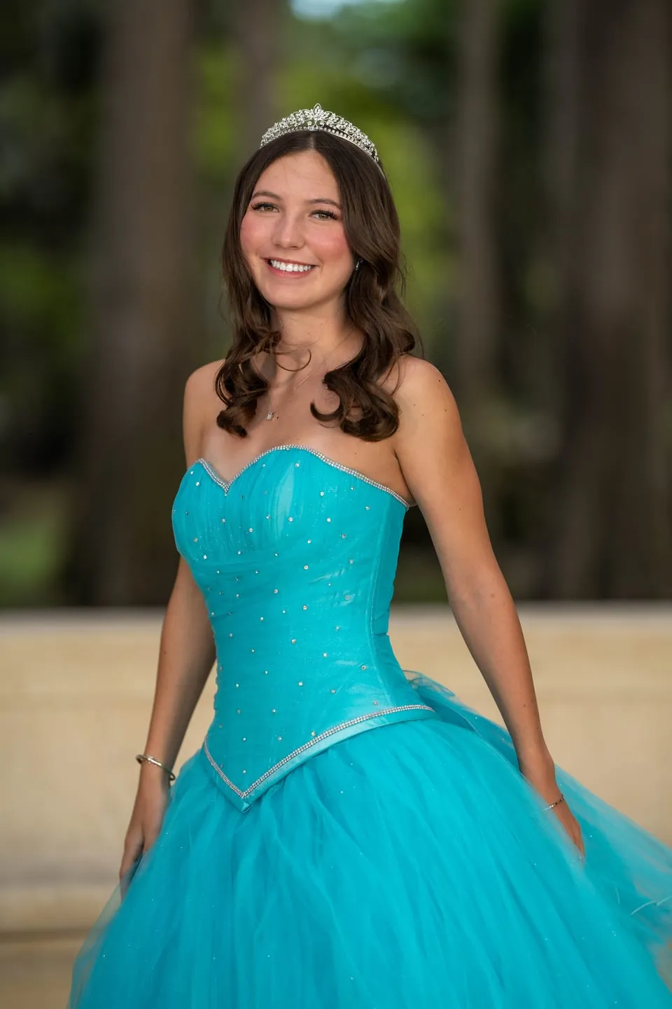 Formal quinceañera portrait in a turquoise gown and tiara in Central Florida by Pottinger Studios